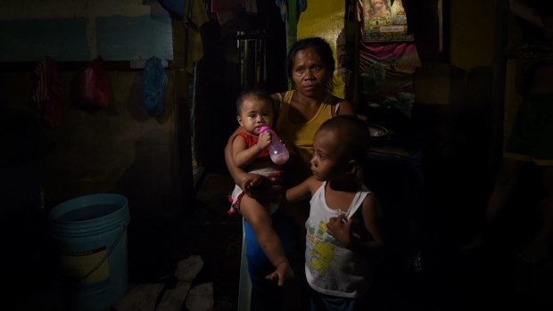 Ruth-Jane Sombrio, whose husband was shot dead at home, with her daughter Rogielyn and son Rogie Sebastian.