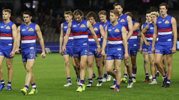 The Bulldogs leave the ground after their loss to the Demons.
