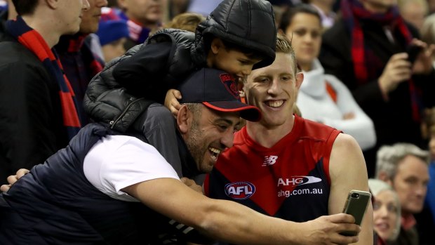 High flyer: Happy Melbourne fans with Sam Frost after their win over the Bulldogs.