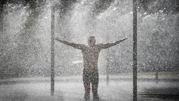 New Zealander Soteri Katsougiannis cools off in a fountain in Melbourne's CBD on Thursday.