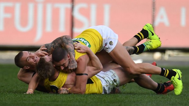 Dustin Martin, Jack Riewoldt and Shaun Grigg in raptures after their win.