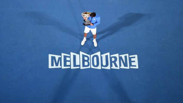 King of the court: Novak Djokovic poses with the Norman Brookes Trophy after beating Andy Murray to the 2015 Australian Open crown.