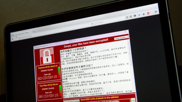 A screenshot of the warning screen from a purported ransomware attack, as captured by a computer user in Taiwan, is seen on laptop in Beijing.