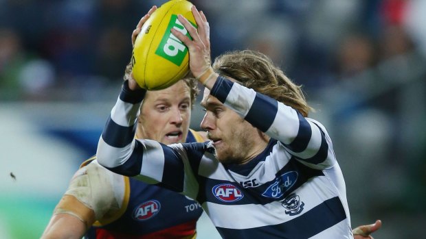 High stakes: Rory Sloane tackles Cameron Guthrie of the Cats.