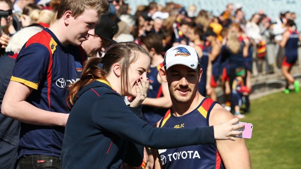 One of the gang: Crows skipper Taylor Walker poses with fans.