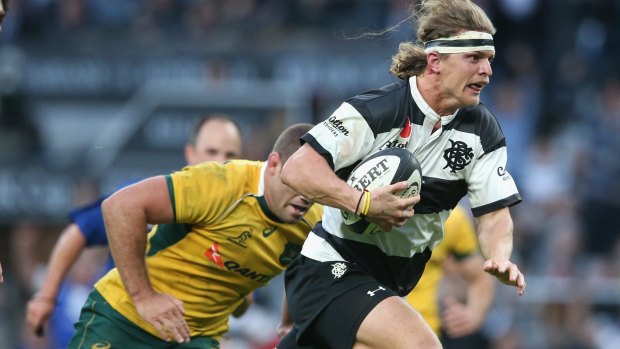 On the burst: Nick Cummins breaks clear to lead the Barbarians fightback.