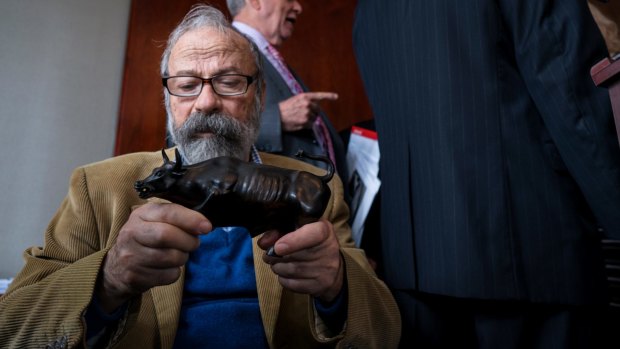 Arturo Di Modica holds a model of his <em>Charging Bull</em> sculpture during a news conference in New York this month.
