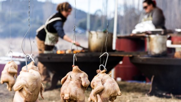 A junkyard barbecue, complete with chickens hanging from the hills hoist, at the Huon Valley Mid-Winter Festival.