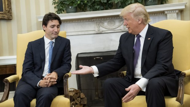 President Donald Trump, right, extends his hand to Justin Trudeau, Canada's Prime Minister, during a meeting in the Oval Office.