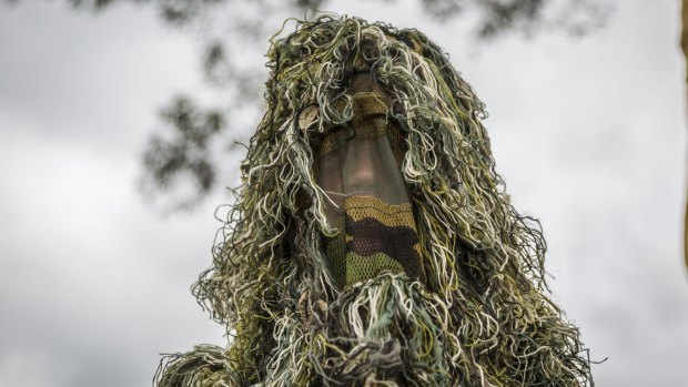 A scout dressed in a ghillie suit arrives for the 24th Australian Jamboree. 