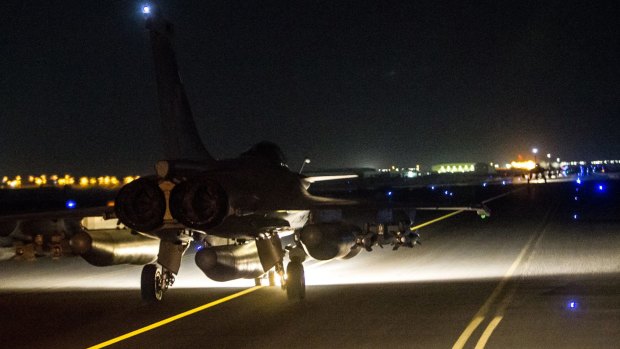 A French jet on the tarmac of an undisclosed air base. France launched "massive" air strikes on Raqqa, the Islamic State group's de-facto capital in Syria on Sunday night, where Iraqi intelligence officials say the attacks on Paris were planned. 