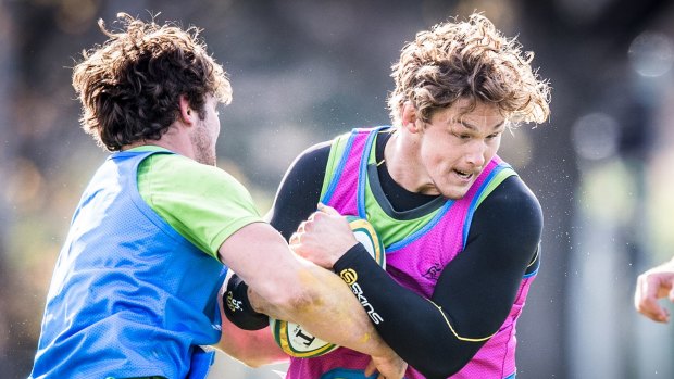 Liam Gill tackles Michael Hooper at a Wallabies training session.