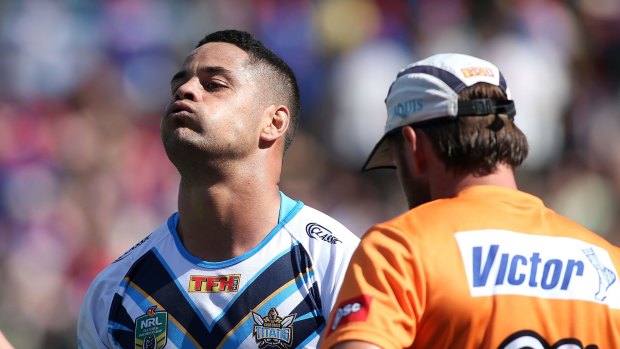 Out for a month: Jarryd Hayne leaves the field with an ankle injury during the Titans' loss to Newcastle at the weekend.