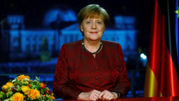 German Chancellor Angela Merkel poses for photographs after the television recording of her annual New Year's speech.