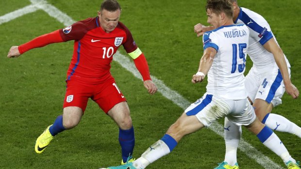 No way through: Wayne Rooney looks to pick his way through the Slovakia defence.