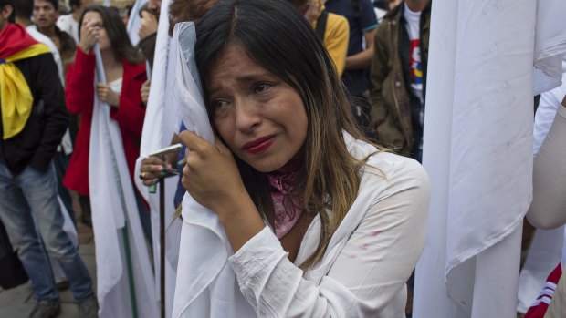 A woman reacts after learning about the rejection of a peace deal with the FARC.