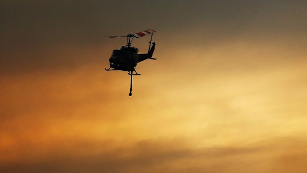 Helicopters carry water as part of reduction drops in Warrimoo.