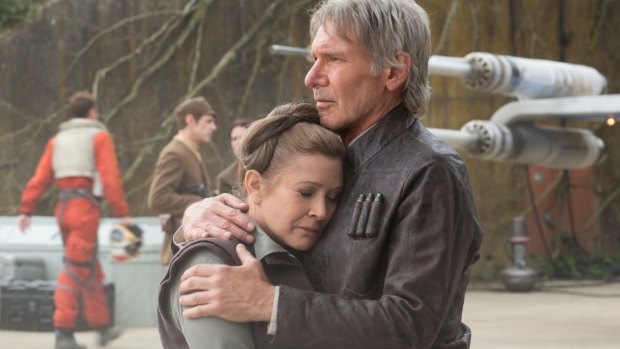 Carrie Fisher and Harrison Ford share a tender moment in <i>The Force Awakens</I>.