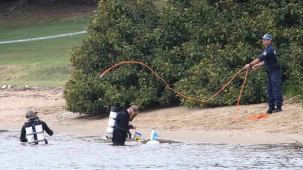 Police divers search the water around Cabarita Wharf, where the body of a woman was found.