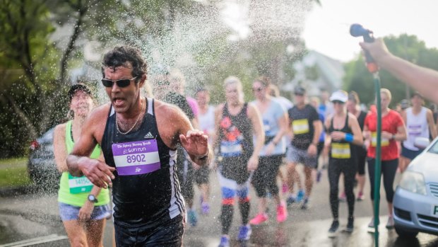 Runners get water relief at The Sydney Morning Herald Sun Run on Saturday.