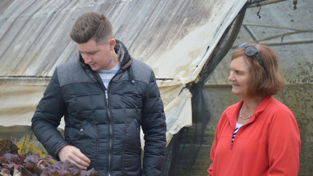 Jed Gerrard samples fresh vegetables with Bev Shapland.