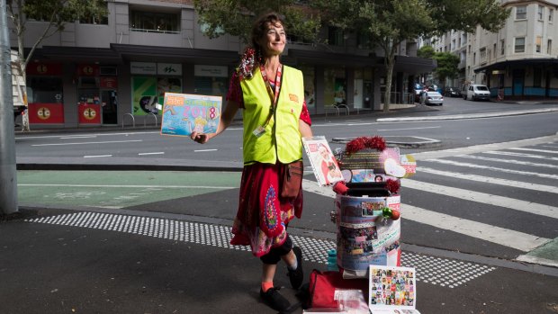 Big Issue vendor Rachel T stands with her trolley in Pyrmont where she has a regular spot. 