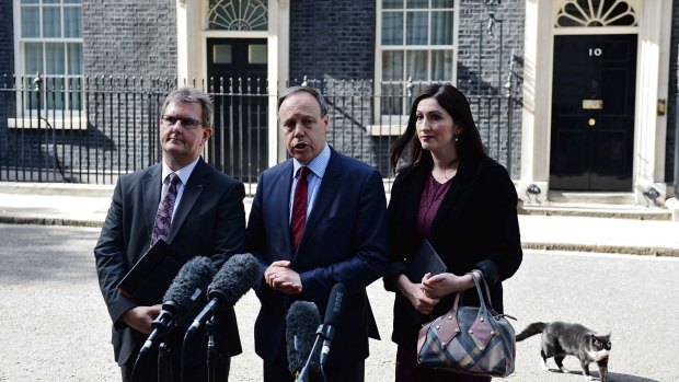 Nigel Dodds, centre, deputy leader of the DUP stands with colleagues after meeting with Theresa May on Thursday.