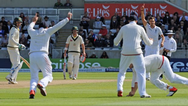 England's Steven Finn (right) celebrates after taking the wicket of Michael Clarke (left), caught by Adam Lyth for three.