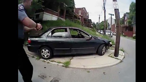 University of Cincinnati police officer Ray Tensing approaches a car with his gun drawn.