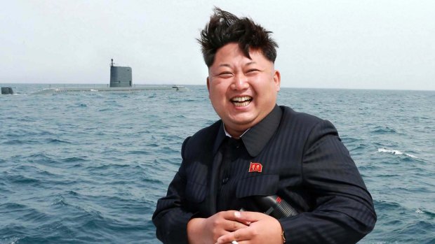 North Korean leader Kim Jong-Un smiles while observing what his government said was an underwater test-fire of a submarine-launched ballistic missile at an undisclosed location at sea. 