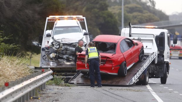 Crashed and towed ... A car is removed from the Monash after Friday morning's incident.