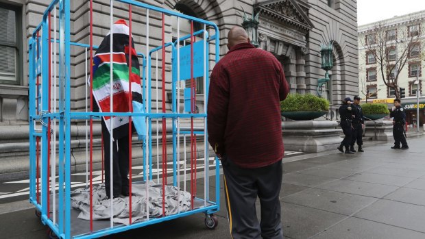 A mannequin wrapped in a composite of flags from the seven countries affected by the travel ban, outside the US court in San Francisco. 