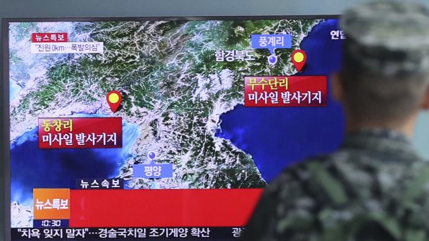 A South Korean marine watches a TV screen reporting about North Korea's possible nuclear test.