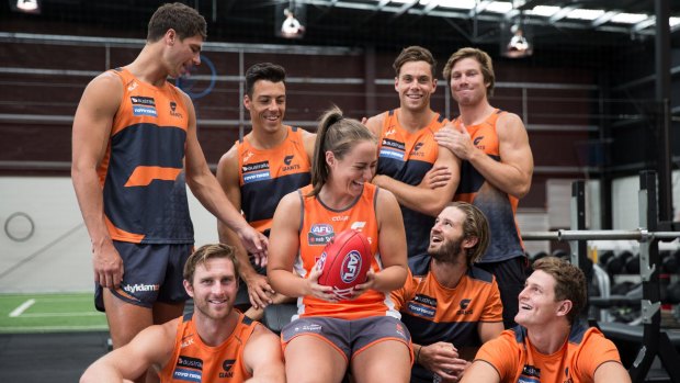 Multi-tasker: Giants back pocket Alex Saundry (centre) with some of the Giants players she manages. Back row, from left: Jonathon Patton, Dylan Shiel, Josh Kelly, Toby Greene and (front row, from left) Dawson Simpson, Alex Saundry, Callan Ward, Jacob Hopper. 