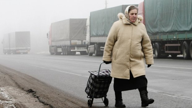 A pedestrian makes her way towards the border of Belarus and Lithuania.The Schengen allows unhindered travel between 26 states.