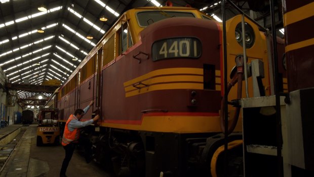 The Large Erecting Shop manager Alan Gardner climbs aboard a carriage at Eveleigh Railway Precinct, Eveleigh. 