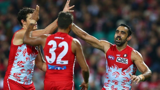 Over she goes: Adam Goodes of the Swans celebrates kicking a goal.