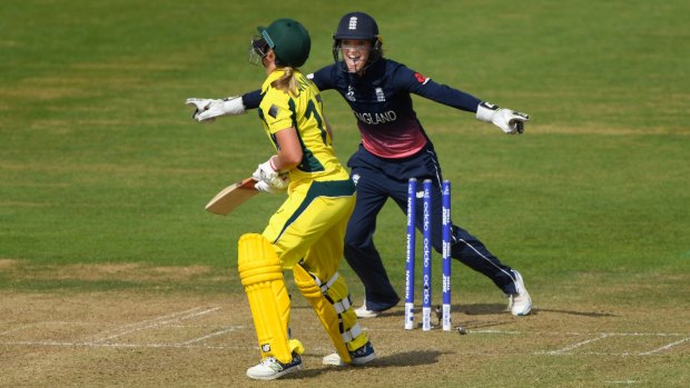 Key wicket: England keeper Sarah Taylor celebrates as Meg Lanning is bowled for 40 runs.