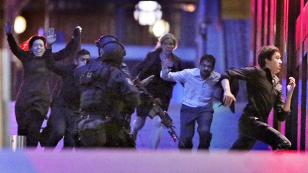 Hostages flee from the Lindt cafe during the siege.
