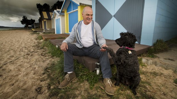 Kevin Egan relaxes on the beach at home in Rye with his dog, Lola. 