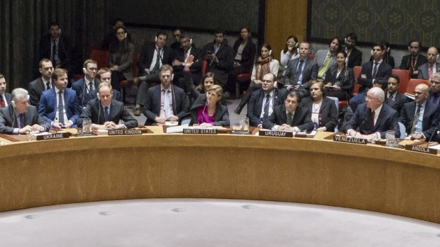 US ambassador to the UN Samantha Power, centre, raises her hand to abstain during the UN Security Council vote on 23 December.