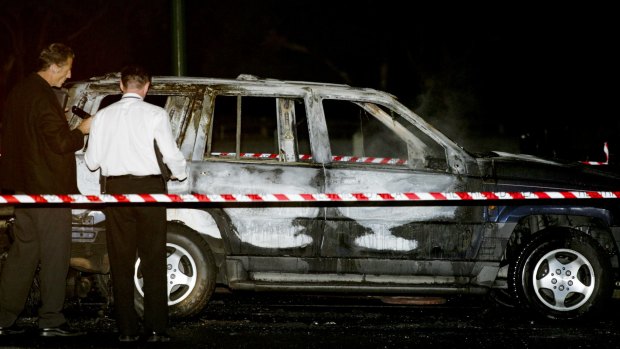 Homicide detectives at the scene in 2008 where Mr Russouw's burnt-out jeep was found in Burwood East.