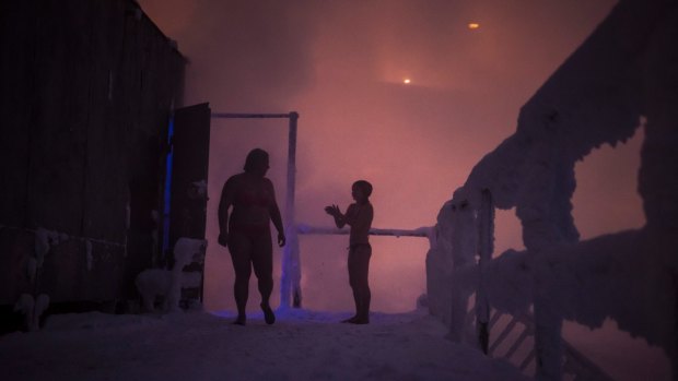 People at the swimming club Walruses of Taimyr emerge from a sauna to take a dip in icy waters in Norilsk.