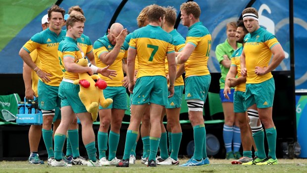 Australian players look dejected in defeat after the Men's Rugby Sevens  match against Argentina.