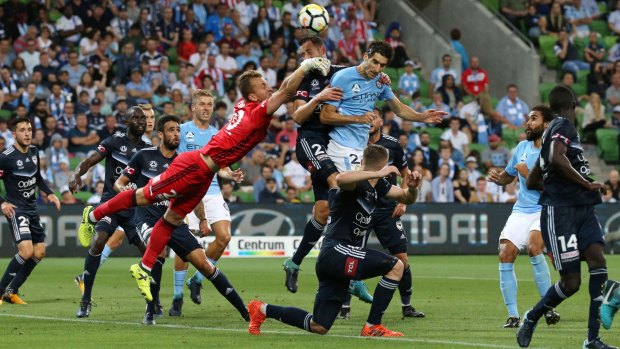 Tale of two keepers: Lawrence Thomas of Melbourne Victory clears the ball from a congested red zone.