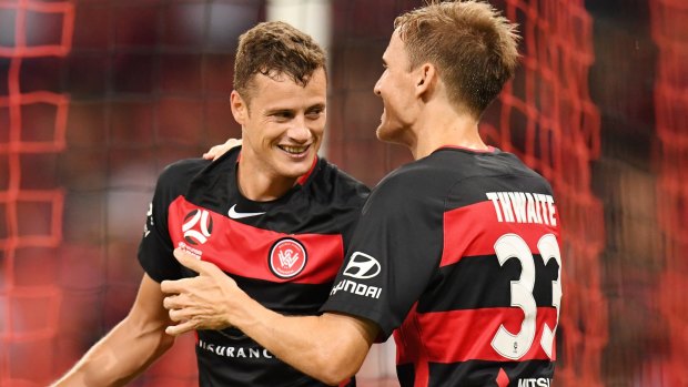 Oriol Riera (left) of the Wanderers celebrates adding to his goal tally with Michael Thwaite.