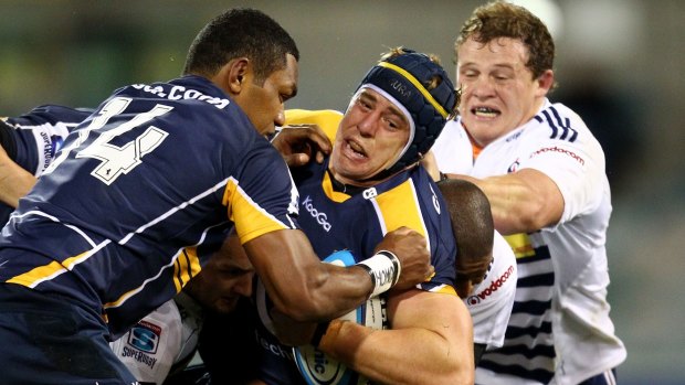 On the move: Mark Chisholm, centre, in action for the Brumbies in 2011.