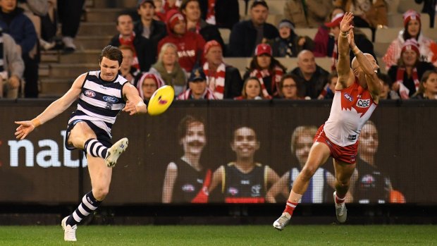 Swan dive: Sydney's Jarrod McVeigh, in his 300th game, tries to spoil Patrick Dangerfield of the Cats.