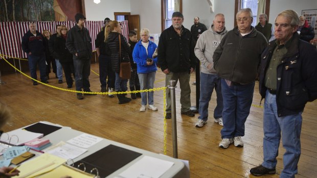 Voters wait in line at the Chichester Town Hall in Chichester, New Hampshire.