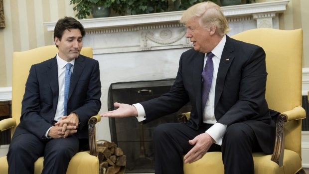 President Donald Trump, right, extends his hand to Justin Trudeau, Canada's Prime Minister, during a meeting in the Oval Office.